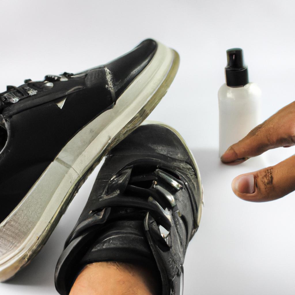 Person applying shoe deodorizer spray